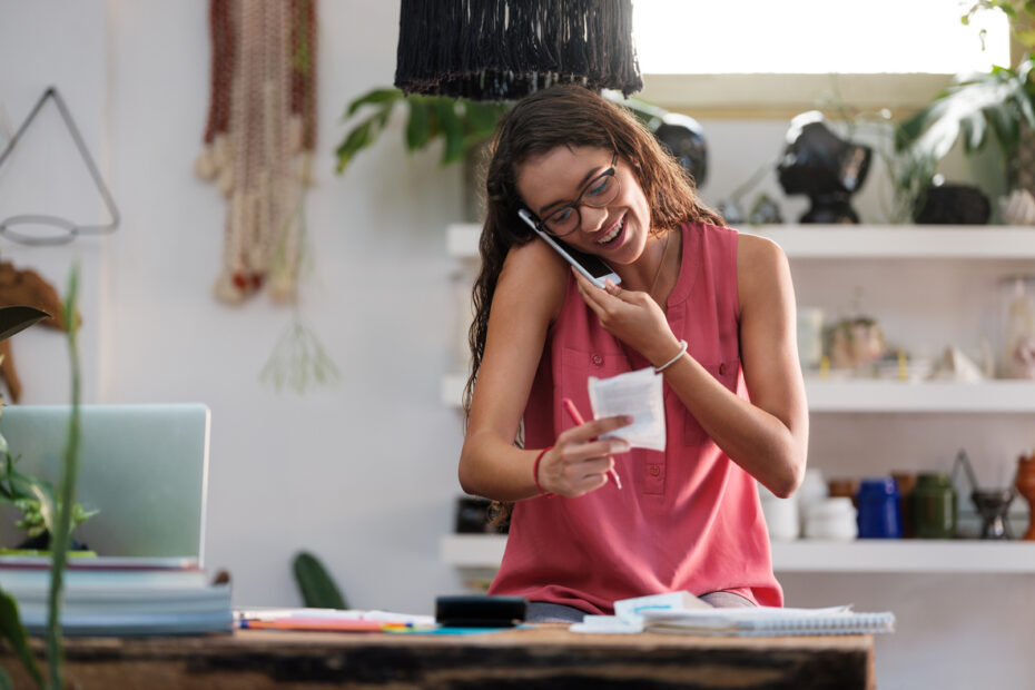 Young small business owner talking on the phone about PPP loan