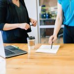 two women in office looking over a document