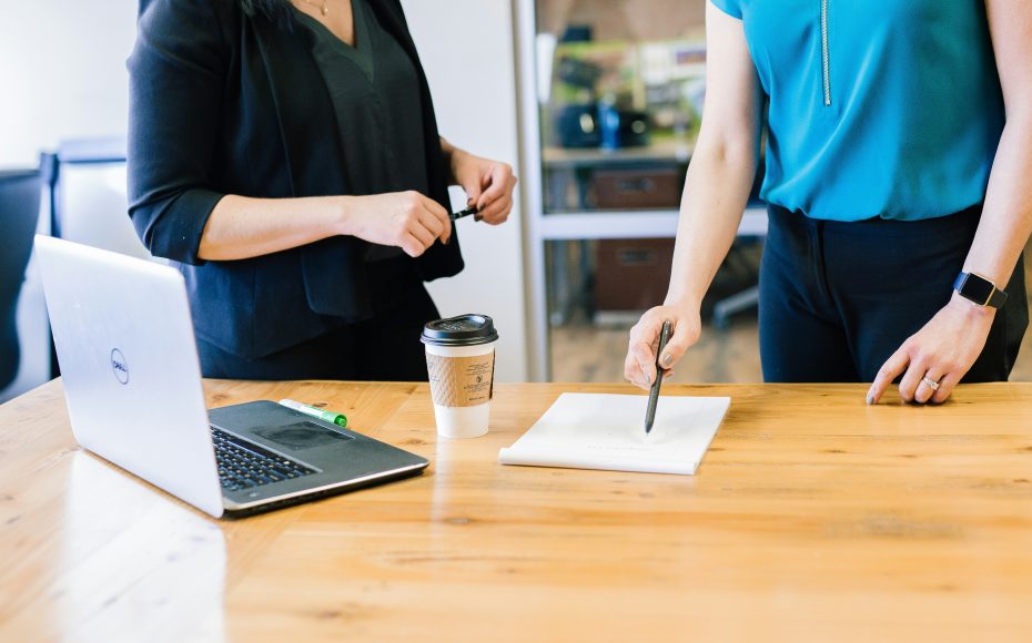 two women in office looking over a document