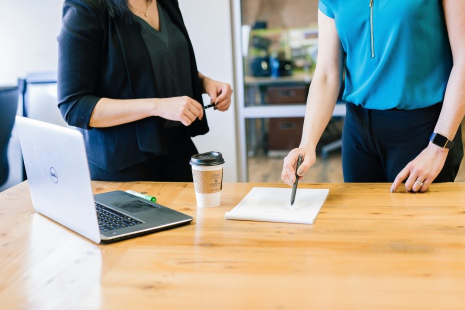 two women in office looking over a document