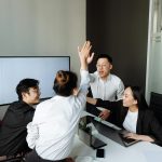 employees high five each other