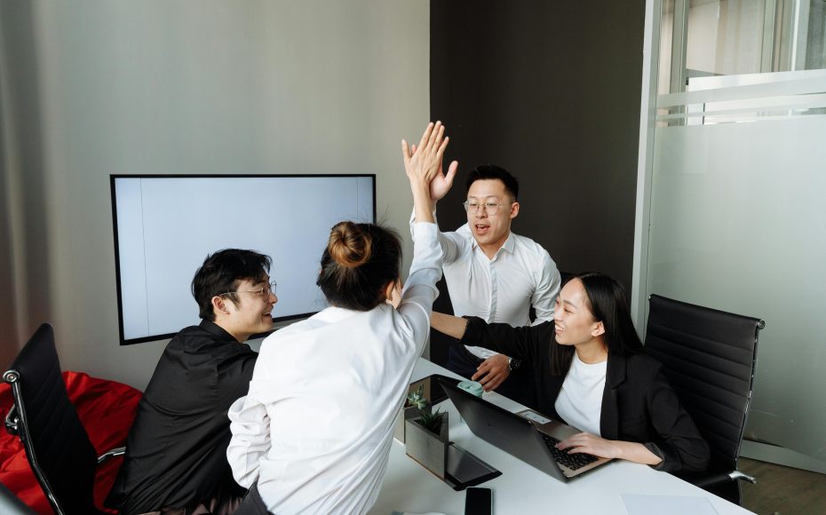 employees high five each other