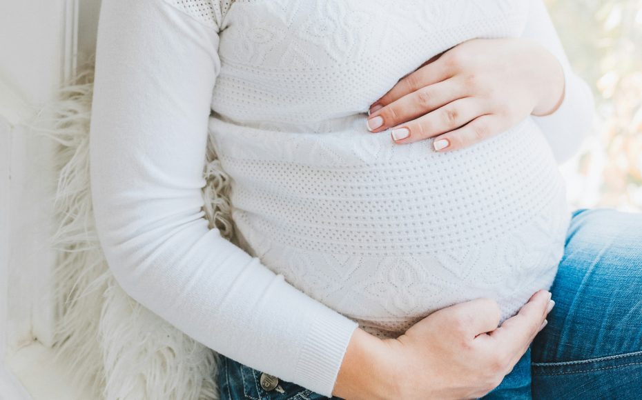 pregnant woman holding her bump