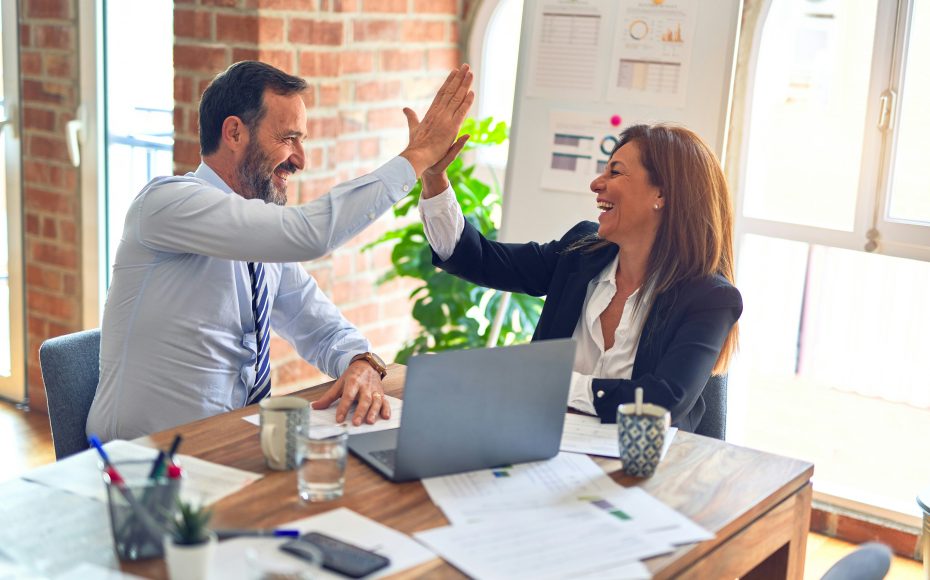 coworkers high fiving each other