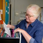 woman looking through file cabinet