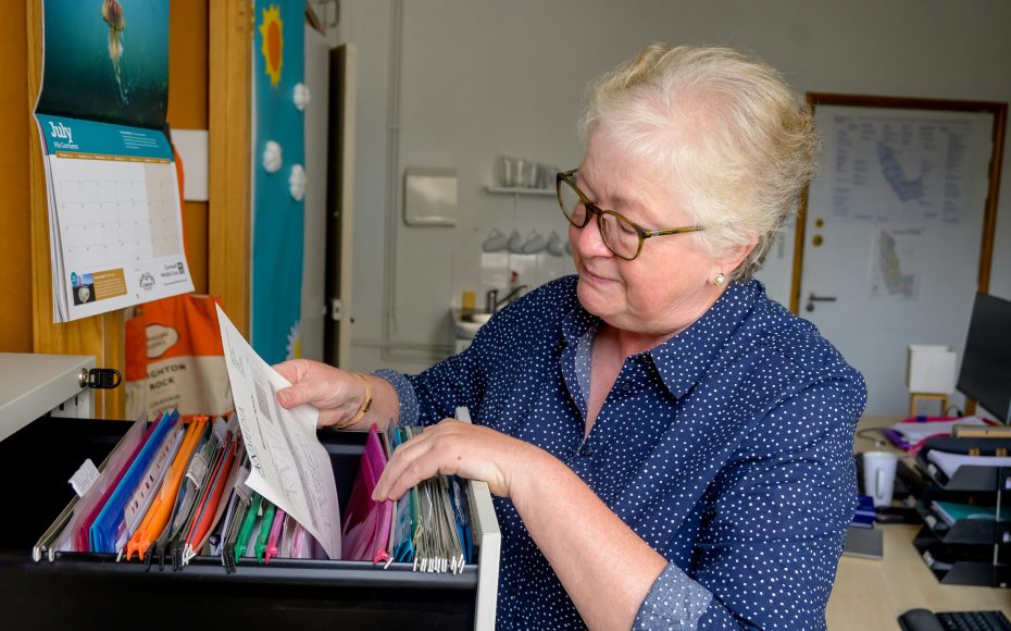 woman looking through file cabinet